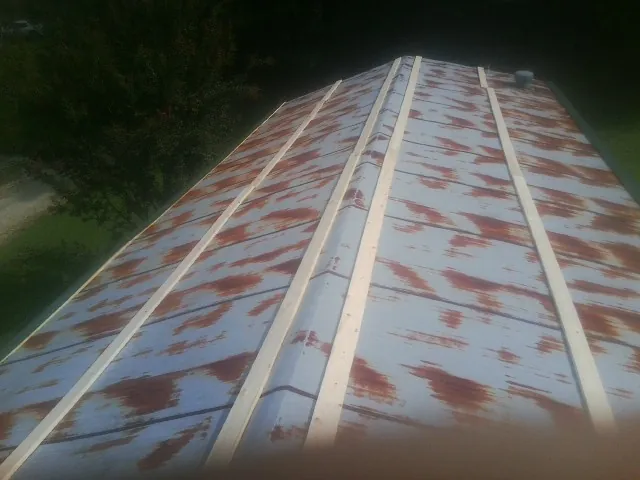 Rusted metal roof panels with new wood purlins before replacement — Storm Damage Roof Repair in Latrobe by Roofing Brothers