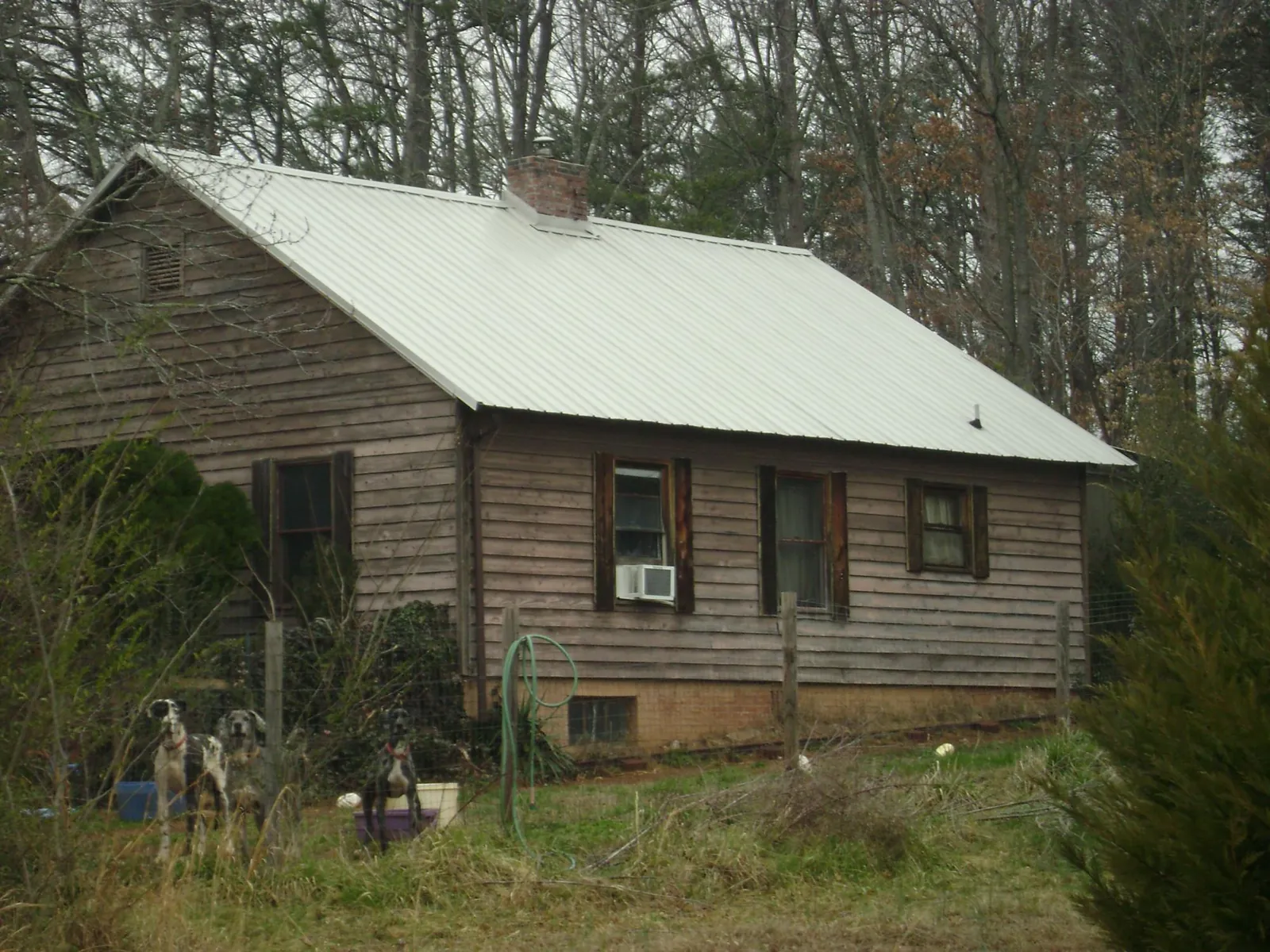 White metal roof on an old wood sided farmhouse, from a Metal Roof Installation job in Latrobe